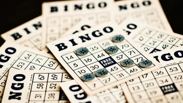 Bingo caller number board above the tables
