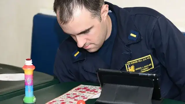 Player marking a bingo card with an ink dauber