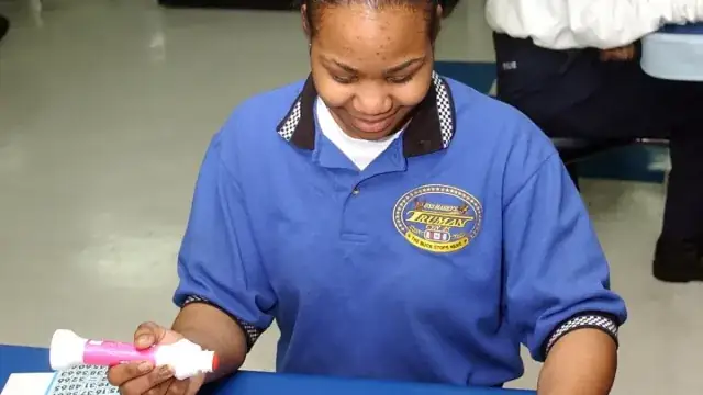 Player using a bingo dauber on paper cards